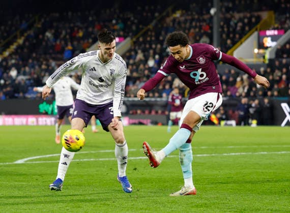 Burnley, England, 7th January 2026. Bashir Humphreys of Burnley (r) clears under pressure from Benjamin Sesko of Manchester United, ManU (l) during the Burnley vs Manchester United Premier League match at Turf Moor, Burnley. Picture credit should read: Cody Froggatt Sportimage EDITORIAL USE ONLY. No use with unauthorised audio, video, data, fixture lists, club league logos or live services. Online in-match use limited to 120 images, no video emulation. No use in betting, games or single club league player publications. SPI_058_CF_Burnley_Man_Utd_ SPI-4437-0057