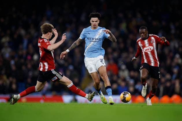 Nico O Reilly of Manchester City is challenged by Ilmari Niskanen of Exeter City and Carlos Mendes Gomes of Exeter City Manchester City v Exeter City, Emirates FA Cup, Third Round, Football, Etihad Stadium, Manchester, UK - 10 Jan 2026Manchester Etihad Stadium United Kingdom EDITORIAL USE ONLY No use with unauthorised audio, video, data, fixture lists, club league logos or live services. Online in-match use limited to 120 images, no video emulation. No use in betting, games or single club league player publications. Copyright: xWillxCooper Shutterstockx 16246255ah
