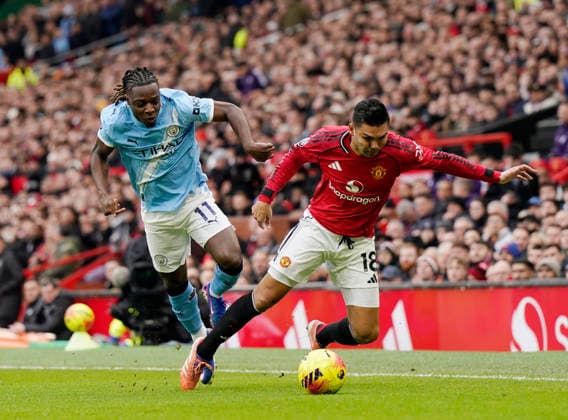 Manchester, England, 17th January 2026. Casemiro of Manchester United, ManU (l) tussles with Jeremy Doku of Manchester City (r) during the Manchester United vs Manchester City Premier League match at Old Trafford, Manchester. Picture credit should read: Andrew Yates Sportimage EDITORIAL USE ONLY. No use with unauthorised audio, video, data, fixture lists, club league logos or live services. Online in-match use limited to 120 images, no video emulation. No use in betting, games or single club league player publications. SPI_038_AY_ManUtd_ManCity SPI-4456-0037