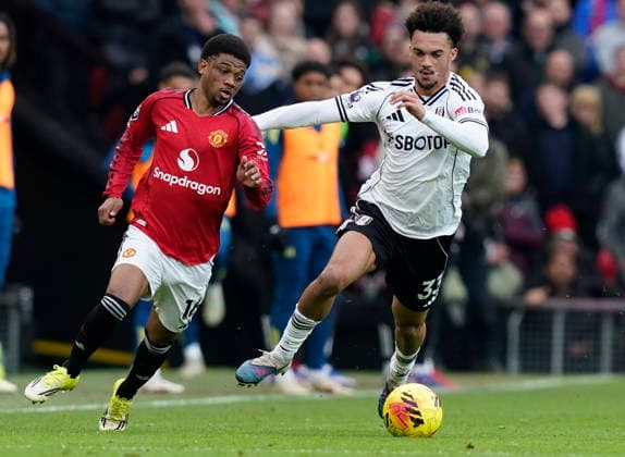 Manchester, England, 1st February 2026. Amad Diallo of Manchester United, ManU (L) is challenged by Antonee Robinson of Fulham during the Manchester United vs Fulham Premier League match at Old Trafford, Manchester. Picture credit should read: Andrew Yates Sportimage EDITORIAL USE ONLY. No use with unauthorised audio, video, data, fixture lists, club league logos or live services. Online in-match use limited to 120 images, no video emulation. No use in betting, games or single club league player publications. SPI_032_AY_MAN_UTD_FULHAM SPI-4502-0031