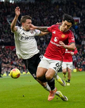 Manchester, England, 1st February 2026. Timothy Castagne of Fulham (L) is challenged by Lisandro Martinez of Manchester United, ManU during the Manchester United vs Fulham Premier League match at Old Trafford, Manchester. Picture credit should read: Andrew Yates Sportimage EDITORIAL USE ONLY. No use with unauthorised audio, video, data, fixture lists, club league logos or live services. Online in-match use limited to 120 images, no video emulation. No use in betting, games or single club league player publications. SPI_037_AY_MAN_UTD_FULHAM SPI-4502-0036