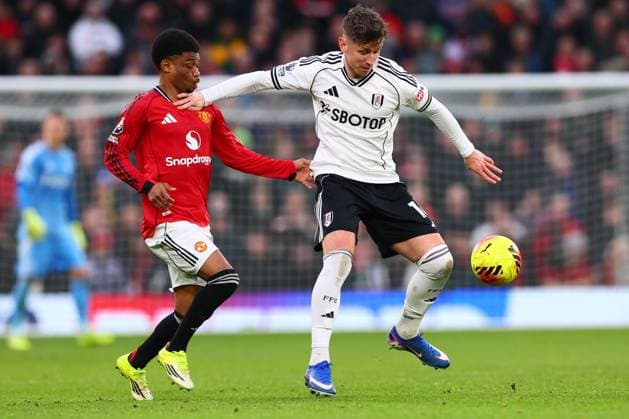 Amad Diallo of Manchester United, ManU and Tom Cairney of Fulham Manchester United v Fulham, Premier League, Football, Old Trafford, Manchester, UK - 01 Feb 2026Manchester Old Trafford United Kingdom EDITORIAL USE ONLY No use with unauthorised audio, video, data, fixture lists, club league logos or live services. Online in-match use limited to 120 images, no video emulation. No use in betting, games or single club league player publications. Copyright: xPaulxCurrie Shutterstockx 16496861jm