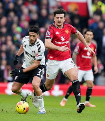 Manchester, England, 1st February 2026. Raul Jimenez of Fulham (L) is challenged by Harry Maguire of Manchester United, ManU during the Manchester United vs Fulham Premier League match at Old Trafford, Manchester. Picture credit should read: Andrew Yates Sportimage EDITORIAL USE ONLY. No use with unauthorised audio, video, data, fixture lists, club league logos or live services. Online in-match use limited to 120 images, no video emulation. No use in betting, games or single club league player publications. SPI_061_AY_MAN_UTD_FULHAM SPI-4502-0060