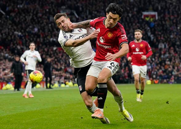 Manchester, England, 1st February 2026. Timothy Castagne of Fulham (L) is challenged by Lisandro Martinez of Manchester United, ManU during the Manchester United vs Fulham Premier League match at Old Trafford, Manchester. Picture credit should read: Andrew Yates Sportimage EDITORIAL USE ONLY. No use with unauthorised audio, video, data, fixture lists, club league logos or live services. Online in-match use limited to 120 images, no video emulation. No use in betting, games or single club league player publications. SPI_067_AY_MAN_UTD_FULHAM SPI-4502-0066