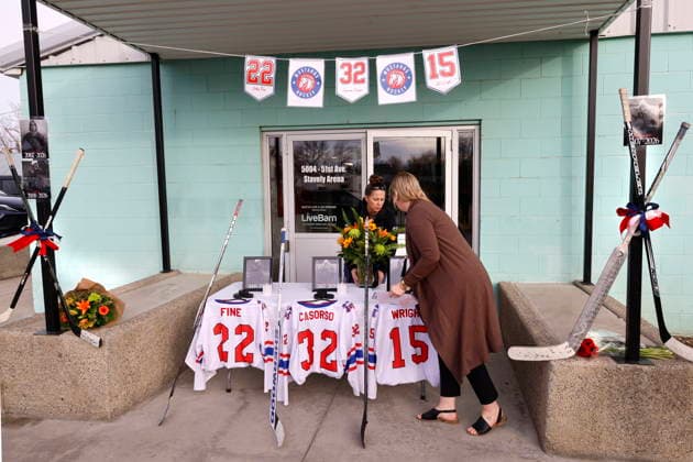 February 3, 2026, Stavely, Ab, Canada: Ag members Candice Usted, left, and Chantelle Scott prepare a memorial outside main arena doors for three junior hockey players killed in a vehicle crash at Stavely, Alta., Feb. 3, 2026. Candice Usted, Chantelle Scott - ZUMAc35_ 20260203_zaf_c35_094 Copyright: xLarryxMacdougalx