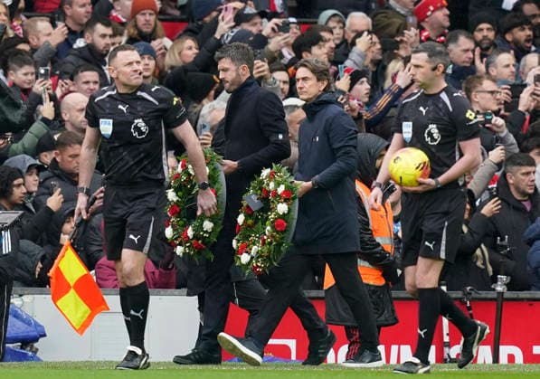 Manchester, England, 7th February 2026. Michael Carrick head coach of Manchester United, ManU and Thomas Frank coach of Tottenham carry wreaths in memory of the Busby Babes before the Manchester United vs Tottenham Hotspur Premier League match at Old Trafford, Manchester. Picture credit should read: Andrew Yates Sportimage EDITORIAL USE ONLY. No use with unauthorised audio, video, data, fixture lists, club league logos or live services. Online in-match use limited to 120 images, no video emulation. No use in betting, games or single club league player publications. SPI_031_AY_Man_Utd_Spurs SPI-4511-0031