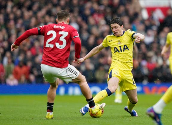 Manchester, England, 7th February 2026. Luke Shaw of Manchester United, ManU tackles Connor Gallagher of Tottenham before the Manchester United vs Tottenham Hotspur Premier League match at Old Trafford, Manchester. Picture credit should read: Andrew Yates Sportimage EDITORIAL USE ONLY. No use with unauthorised audio, video, data, fixture lists, club league logos or live services. Online in-match use limited to 120 images, no video emulation. No use in betting, games or single club league player publications. SPI_038_AY_Man_Utd_Spurs SPI-4511-0038