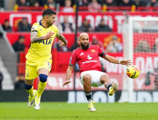 Manchester, England, 7th February 2026. Cristian Romero of Tottenham (l) tackles Bryan Mbeumo of Manchester United, ManU (r) before the Manchester United vs Tottenham Hotspur Premier League match at Old Trafford, Manchester. Picture credit should read: Andrew Yates Sportimage EDITORIAL USE ONLY. No use with unauthorised audio, video, data, fixture lists, club league logos or live services. Online in-match use limited to 120 images, no video emulation. No use in betting, games or single club league player publications. SPI_040_AY_Man_Utd_Spurs SPI-4511-0040