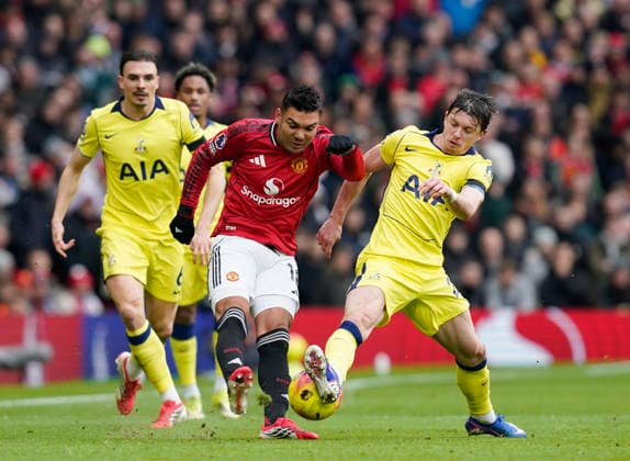 Manchester, England, 7th February 2026. Casemiro of Manchester United, ManU tackled by Connor Gallagher of Tottenham during the Manchester United vs Tottenham Hotspur Premier League match at Old Trafford, Manchester. Picture credit should read: Andrew Yates Sportimage EDITORIAL USE ONLY. No use with unauthorised audio, video, data, fixture lists, club league logos or live services. Online in-match use limited to 120 images, no video emulation. No use in betting, games or single club league player publications. SPI_046_AY_Man_Utd_Spurs SPI-4511-0046