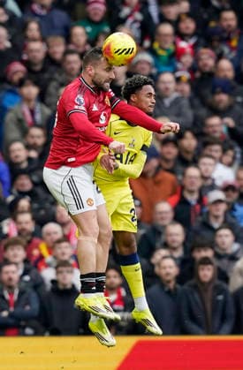 Manchester, England, 7th February 2026. Luke Shaw of Manchester United, ManU wins a header against Wilson Odobert of Tottenham during the Manchester United vs Tottenham Hotspur Premier League match at Old Trafford, Manchester. Picture credit should read: Andrew Yates Sportimage EDITORIAL USE ONLY. No use with unauthorised audio, video, data, fixture lists, club league logos or live services. Online in-match use limited to 120 images, no video emulation. No use in betting, games or single club league player publications. SPI_047_AY_Man_Utd_Spurs SPI-4511-0047
