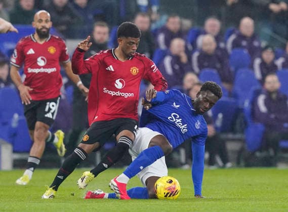 Liverpool, England, 23rd February 2026. Amad Diallo of Manchester United, ManU tackles Tim Iroegbunam of Everton during the Everton vs Manchester United Premier League match at Hill Dickinson Stadium, Liverpool. Picture credit should read: Andrew Yates Sportimage EDITORIAL USE ONLY. No use with unauthorised audio, video, data, fixture lists, club league logos or live services. Online in-match use limited to 120 images, no video emulation. No use in betting, games or single club league player publications. SPI_017_AY_Everton_Man_Utd SPI-4547-0017