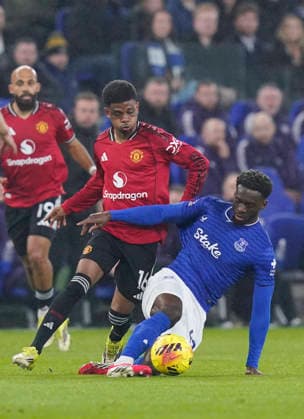 Liverpool, England, 23rd February 2026. Amad Diallo of Manchester United, ManU tackles Tim Iroegbunam of Everton during the Everton vs Manchester United Premier League match at Hill Dickinson Stadium, Liverpool. Picture credit should read: Andrew Yates Sportimage EDITORIAL USE ONLY. No use with unauthorised audio, video, data, fixture lists, club league logos or live services. Online in-match use limited to 120 images, no video emulation. No use in betting, games or single club league player publications. SPI_018_AY_Everton_Man_Utd SPI-4547-0018
