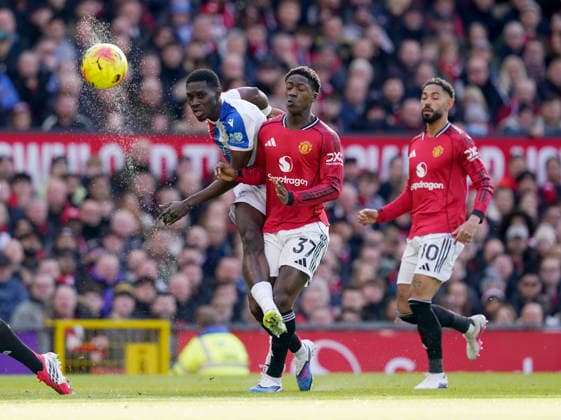 Manchester, England, 1st March 2026. Ismaila Sarr of Crystal Palace takes a shot despite the attentions of Kobbie Mainoo of Manchester United, ManU during the Manchester United vs Crystal Palace Premier League match at Old Trafford, Manchester. Picture credit should read: Andrew Yates Sportimage EDITORIAL USE ONLY. No use with unauthorised audio, video, data, fixture lists, club league logos or live services. Online in-match use limited to 120 images, no video emulation. No use in betting, games or single club league player publications. SPI_024_AY_Man_Utd_Palace SPI-4566-0024