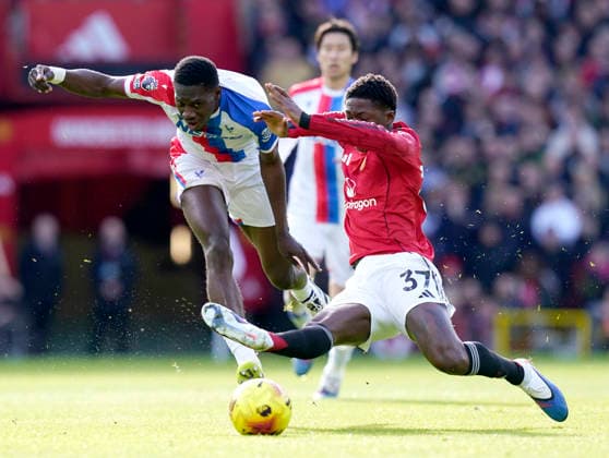 Manchester, England, 1st March 2026. Ismaila Sarr of Crystal Palace tussles with Kobbie Mainoo of Manchester United, ManU during the Manchester United vs Crystal Palace Premier League match at Old Trafford, Manchester. Picture credit should read: Andrew Yates Sportimage EDITORIAL USE ONLY. No use with unauthorised audio, video, data, fixture lists, club league logos or live services. Online in-match use limited to 120 images, no video emulation. No use in betting, games or single club league player publications. SPI_028_AY_Man_Utd_Palace SPI-4566-0028