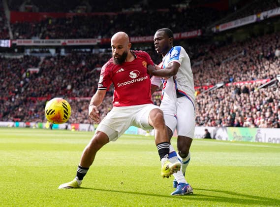 Manchester, England, 1st March 2026. Bryan Mbeumo of Manchester United, ManU tussles with Tyrick Mitchell of Crystal Palace during the Manchester United vs Crystal Palace Premier League match at Old Trafford, Manchester. Picture credit should read: Andrew Yates Sportimage EDITORIAL USE ONLY. No use with unauthorised audio, video, data, fixture lists, club league logos or live services. Online in-match use limited to 120 images, no video emulation. No use in betting, games or single club league player publications. SPI_034_AY_Man_Utd_Palace SPI-4566-0034