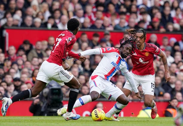 Manchester, England, 1st March 2026. Naouirou Ahamada of Crystal Palace (c) tussles with Leny Yoro of Manchester United, ManU (r) during the Manchester United vs Crystal Palace Premier League match at Old Trafford, Manchester. Picture credit should read: Andrew Yates Sportimage EDITORIAL USE ONLY. No use with unauthorised audio, video, data, fixture lists, club league logos or live services. Online in-match use limited to 120 images, no video emulation. No use in betting, games or single club league player publications. SPI_076_AY_Man_Utd_Palace SPI-4566-0076