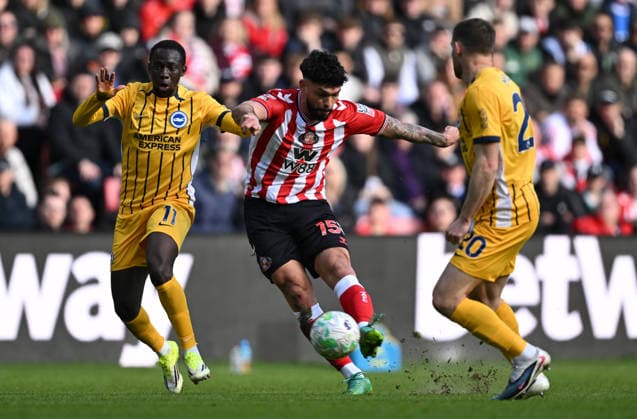Omar Alderete of Sunderland shoots at goal as Yankuba Minteh of Brighton & Hove Albion tackles Sunderland v Brighton and Hove Albion, Premier League, Football, Stadium of Light, Sunderland, UK - 14 Mar 2026Sunderland Stadium of Light United Kingdom EDITORIAL USE ONLY No use with unauthorised audio, video, data, fixture lists, club league logos or live services. Online in-match use limited to 120 images, no video emulation. No use in betting, games or single club league player publications. Copyright: xGreigxCowie Shutterstockx 16757170af