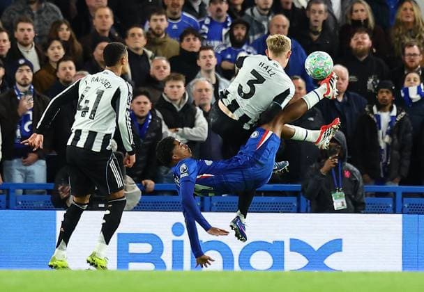 Wesley Fofana of Chelsea has a shot despite the attentions of Lewis Hall of Newcastle United Chelsea v Newcastle United, Premier League, Football, Stamford Bridge, London, UK - 14 Mar 2026London Stamford Bridge United Kingdom EDITORIAL USE ONLY No use with unauthorised audio, video, data, fixture lists, club league logos or live services. Online in-match use limited to 120 images, no video emulation. No use in betting, games or single club league player publications. Copyright: xMichaelxZemanek Shutterstockx 16757240ao