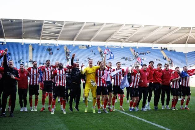 Lincoln City players celebrate their promotion to the Sky Bet Championship Reading v Lincoln City, Sky Bet League One, Football, Select Car Leasing Stadium, Reading, UK - 06 Apr 2026Reading Select Car Leasing Stadium United Kingdom EDITORIAL USE ONLY No use with unauthorised audio, video, data, fixture lists, club league logos or live services. Online in-match use limited to 120 images, no video emulation. No use in betting, games or single club league player publications. Copyright: xSimonxDael Shutterstockx 16811828cd