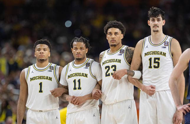 April 6, 2026, Indianapolis, Indiana, USA: Michigans Trey McKinney, Roddy Gayle, Yaxel Lendeborg and Adam Mara gather together during a break in the action against UConn during first half action of the NCAA, College League, USA Mens Basketball Championship. Michigan went on to win 69-63. Monday, April 7, 2026. Indianapolis USA - ZUMAr44_ 20260406_zsp_r44_012 Copyright: xThomasxJ.xRussox