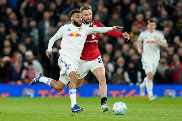 Manchester, England, 13th April 2026. Luke Shaw of Manchester United, ManU and Jayden Bogle of Leeds United challenge for the ball during the Manchester United vs Leeds United Premier League match at Old Trafford, Manchester. Picture credit should read: Andrew Yates Sportimage EDITORIAL USE ONLY. No use with unauthorised audio, video, data, fixture lists, club league logos or live services. Online in-match use limited to 120 images, no video emulation. No use in betting, games or single club league player publications. SPI_052_AY_Man_Utd_Leeds SPI-4684-0052