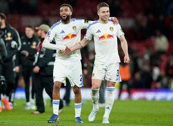 Manchester, England, 13th April 2026. Jayden Bogle (L) and Gabriel Gudmundsson of Leeds United celebrate after the Manchester United, ManU vs Leeds United Premier League match at Old Trafford, Manchester. Picture credit should read: Andrew Yates Sportimage EDITORIAL USE ONLY. No use with unauthorised audio, video, data, fixture lists, club league logos or live services. Online in-match use limited to 120 images, no video emulation. No use in betting, games or single club league player publications. SPI_075_AY_Man_Utd_Leeds SPI-4684-0075