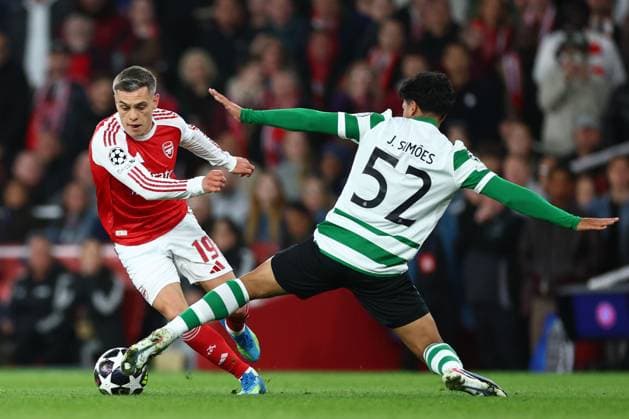 Leandro Trossard of Arsenal tackled by Joao Simoes of Sporting CP Arsenal v Sporting, UEFA Champions League, Quarter Final, Second Leg, Football, Emirates Stadium, London, UK - 15 Apr 2026London Emirates Stadium United Kingdom EDITORIAL USE ONLY No use with unauthorised audio, video, data, fixture lists, club league logos or live services. Online in-match use limited to 120 images, no video emulation. No use in betting, games or single club league player publications. Copyright: xSimonxDael Shutterstockx 16828544bh