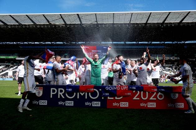 Milton Keynes Dons players celebrate their side s promotion to EFL League One Milton Keynes Dons v Tranmere Rovers, EFL Sky Bet League Two, Football, Stadium MK, Milton Keynes, UK - 25 Apr 2026Milton Keynes Stadium MK United Kingdom EDITORIAL USE ONLY No use with unauthorised audio, video, data, fixture lists, club league logos or live services. Online in-match use limited to 120 images, no video emulation. No use in betting, games or single club league player publications. Copyright: xGeorgexTewkesbury Shutterstockx 16838787bs