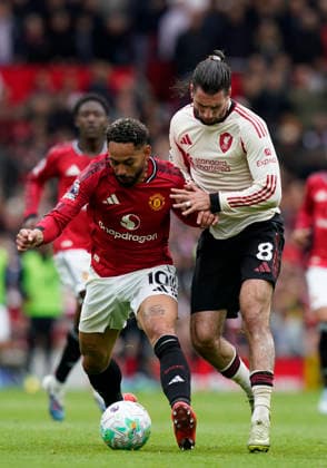 Manchester, England, 3rd May 2026. Matheus Cunha of Manchester United, ManU tussles with Dominik Szoboszlai of Liverpool during the Manchester United vs Liverpool Premier League match at Old Trafford, Manchester. Picture credit should read: Andrew Yates Sportimage EDITORIAL USE ONLY. No use with unauthorised audio, video, data, fixture lists, club league logos or live services. Online in-match use limited to 120 images, no video emulation. No use in betting, games or single club league player publications. SPI_066_AY_MAN_UTD_LIVERPOOL SPI-4776-0065