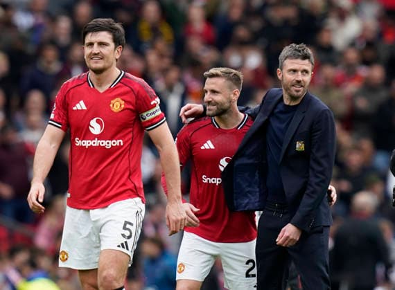 Manchester, England, 3rd May 2026. Harry Maguire of Manchester United, ManU Luke Shaw of Manchester United and Michael Carrick head coach of Manchester United celebrate the win during the Manchester United vs Liverpool Premier League match at Old Trafford, Manchester. Picture credit should read: Andrew Yates Sportimage EDITORIAL USE ONLY. No use with unauthorised audio, video, data, fixture lists, club league logos or live services. Online in-match use limited to 120 images, no video emulation. No use in betting, games or single club league player publications. SPI_108_AY_MAN_UTD_LIVERPOOL SPI-4776-0107