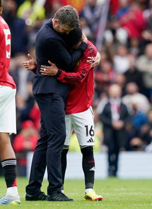 Manchester, England, 3rd May 2026. Michael Carrick head coach of Manchester United, ManU hugs Amad Diallo of Manchester United during the Manchester United vs Liverpool Premier League match at Old Trafford, Manchester. Picture credit should read: Andrew Yates Sportimage EDITORIAL USE ONLY. No use with unauthorised audio, video, data, fixture lists, club league logos or live services. Online in-match use limited to 120 images, no video emulation. No use in betting, games or single club league player publications. SPI_111_AY_MAN_UTD_LIVERPOOL SPI-4776-0111