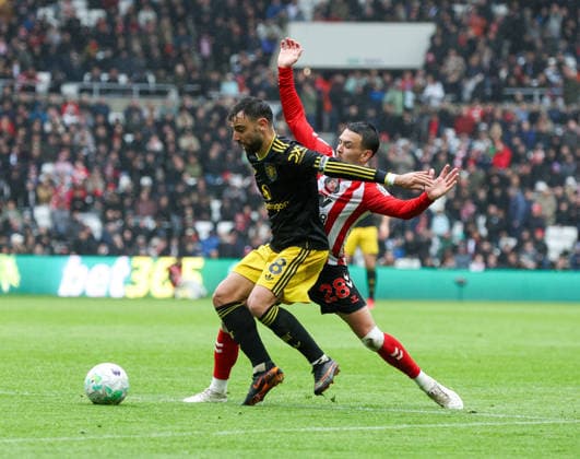 Sunderland, England, 9th May 2026. Bruno Fernandes (L) of Sunderland in action with Enzo Le Fee of Manchester United, ManU during the Sunderland vs Manchester United Premier League match at the Stadium Of Light, Sunderland. Picture credit should read: Nigel Roddis Sportimage EDITORIAL USE ONLY. No use with unauthorised audio, video, data, fixture lists, club league logos or live services. Online in-match use limited to 120 images, no video emulation. No use in betting, games or single club league player publications. SPI_024_NR_SUND_MANC SPI-4790-0024