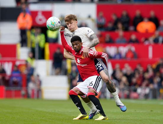 Manchester, England, 17th May 2026. Amad Diallo of Manchester United, ManU tussles with Luca Netz of Nottingham Forest during the Manchester United vs Nottingham Forest Premier League match at Old Trafford, Manchester. Picture credit should read: Andrew Yates Sportimage EDITORIAL USE ONLY. No use with unauthorised audio, video, data, fixture lists, club league logos or live services. Online in-match use limited to 120 images, no video emulation. No use in betting, games or single club league player publications. SPI_041_AY_Man_Utd_Forest SPI-4806-0041