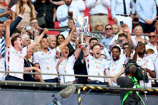 George Johnston of Bolton Wanderers celebrate with the trophy after winning the EFL Championship Play-off Final and promotion to the Premier League Bolton Wanderers v Stockport County, EFL Sky Bet League One, Play-Off Final, Football, Wembley Stadium, London, UK - 24 May 2026London Wembley Stadium United Kingdom EDITORIAL USE ONLY No use with unauthorised audio, video, data, fixture lists, club league logos or live services. Online in-match use limited to 120 images, no video emulation. No use in betting, games or single club league player publications. Copyright: xSimonxDael Shutterstockx 16889811ga