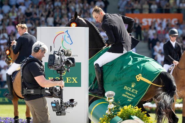 Richard VOGEL (GER) auf United Touch S, raeumt den Rolex Pokal ab, Aktion, bei der Siegerehrung, Springen S6: ROLEX Grand Prix, Part of the ROLEX Grand Slam of Show Jumping, Der grosse Preis von Aachen, Springpruefung mit zwei Umlaeufen und Stechen, CSI5*, am 24.05.2026, Weltfest des Pferdesport, TSCHIO Aachen 2026 vom 22. - 24.05.2026 in Aachen Deutschland; Â