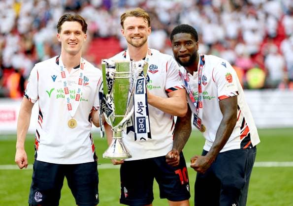 (Left to right) Josh Sheehan, Sam Dalby and Jordi Osei-Tutu of Bolton Wanderers celebrate after winning the Sky Bet EFL League One Play-off Final and promotion to the Sky Bet EFL Championship Bolton Wanderers v Stockport County, EFL Sky Bet League One, Play-Off Final, Football, Wembley Stadium, London, UK - 24 May 2026London Wembley Stadium United Kingdom EDITORIAL USE ONLY No use with unauthorised audio, video, data, fixture lists, club league logos or live services. Online in-match use limited to 120 images, no video emulation. No use in betting, games or single club league player publications. Copyright: xSimonxDael Shutterstockx 16889811il