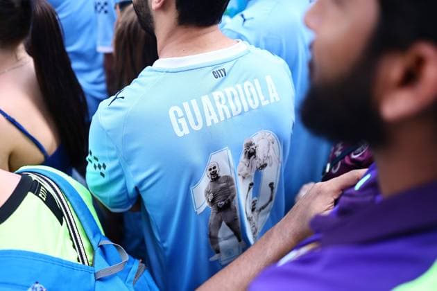 A fan with a Pep Guardiola City shirt Manchester City Carabao Cup and FA Cup trophy Parade, Premier League, Football, Manchester, UK - 25 May 2026Manchester United Kingdom EDITORIAL USE ONLY No use with unauthorised audio, video, data, fixture lists, club league logos or live services. Online in-match use limited to 120 images, no video emulation. No use in betting, games or single club league player publications. Copyright: xPhilxOldham Shutterstockx 16889909l