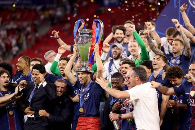 Achraf Hakimi of Paris Saint-Germain celebrates with the trophy and teammatesafter winning the UEFA Champions League Paris Saint-Germain v Arsenal, UEFA Champions League, Final, Football, Puskas Arena, Budapest, Hungary - 30 May 2026Budapest Puskas Arena Hungary EDITORIAL USE ONLY No use with unauthorised audio, video, data, fixture lists, club league logos or live services. Online in-match use limited to 120 images, no video emulation. No use in betting, games or single club league player publications. Copyright: xAhmadxMora Shutterstockx 16902827eq