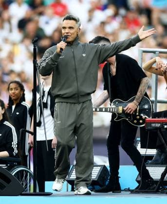 Robbie Williams performs during a half time show. England XI v World XI, Soccer Aid for Unicef 2026, Football, London Stadium, London, UK - 31 May 2026London London Stadium United Kingdom EDITORIAL USE ONLY No use with unauthorised audio, video, data, fixture lists, club league logos or live services. Online in-match use limited to 120 images, no video emulation. No use in betting, games or single club league player publications. Copyright: xJamesxMarsh Shutterstockx 16898311bv
