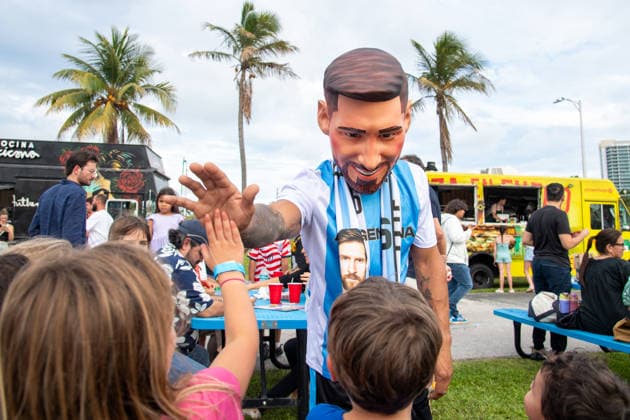 MIAMI, FL - JUNE 09: A person dressed to look like Lionel Messi wearing an Argentina national team, Nationalteam jersey interacts with event attendees on June 9, 2026 at Haulover Park, in Miami, FL. The Food Trucks Tuesdays event at Haulover Park is a weekly free admission community event featuring local food vendors, family-friendly activities, music, and kite flying. Recent events include Panini FIFA World Cup, WM, Weltmeisterschaft, Fussball 2026 Sticker trading, with a goal of helping collectors fill their albums. The performer dressed like Lionel Messi was introduced to attendees as a surprise guest visiting ahead of the 2026 FIFA World Cup. (Photo by Erica Denhoff Icon Sportswire) SOCCER: JUN 09 Food Trucks Tuesdays at Haulover Park EDITORIAL USE ONLY Icon260905