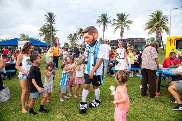 MIAMI, FL - JUNE 09: A person dressed to look like Lionel Messi wearing an Argentina national team, Nationalteam jersey interacts with event attendees on June 9, 2026 at Haulover Park, in Miami, FL. The Food Trucks Tuesdays event at Haulover Park is a weekly free admission community event featuring local food vendors, family-friendly activities, music, and kite flying. Recent events include Panini FIFA World Cup, WM, Weltmeisterschaft, Fussball 2026 Sticker trading, with a goal of helping collectors fill their albums. The performer dressed like Lionel Messi was introduced to attendees as a surprise guest visiting ahead of the 2026 FIFA World Cup. (Photo by Erica Denhoff Icon Sportswire) SOCCER: JUN 09 Food Trucks Tuesdays at Haulover Park EDITORIAL USE ONLY Icon260907