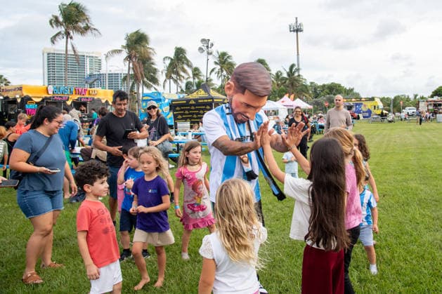 MIAMI, FL - JUNE 09: A person dressed to look like Lionel Messi wearing an Argentina national team, Nationalteam jersey interacts with event attendees on June 9, 2026 at Haulover Park, in Miami, FL. The Food Trucks Tuesdays event at Haulover Park is a weekly free admission community event featuring local food vendors, family-friendly activities, music, and kite flying. Recent events include Panini FIFA World Cup, WM, Weltmeisterschaft, Fussball 2026 Sticker trading, with a goal of helping collectors fill their albums. The performer dressed like Lionel Messi was introduced to attendees as a surprise guest visiting ahead of the 2026 FIFA World Cup. (Photo by Erica Denhoff Icon Sportswire) SOCCER: JUN 09 Food Trucks Tuesdays at Haulover Park EDITORIAL USE ONLY Icon260910