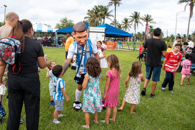 MIAMI, FL - JUNE 09: A person dressed to look like Lionel Messi wearing an Argentina national team, Nationalteam jersey interacts with event attendees on June 9, 2026 at Haulover Park, in Miami, FL. The Food Trucks Tuesdays event at Haulover Park is a weekly free admission community event featuring local food vendors, family-friendly activities, music, and kite flying. Recent events include Panini FIFA World Cup, WM, Weltmeisterschaft, Fussball 2026 Sticker trading, with a goal of helping collectors fill their albums. The performer dressed like Lionel Messi was introduced to attendees as a surprise guest visiting ahead of the 2026 FIFA World Cup. (Photo by Erica Denhoff Icon Sportswire) SOCCER: JUN 09 Food Trucks Tuesdays at Haulover Park EDITORIAL USE ONLY Icon260914