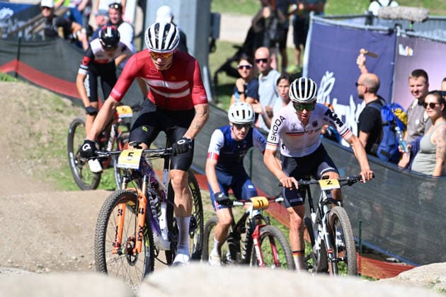 XCO Olympic Cross-Country - Under 23 Men Gustav Pedersen of Denmark, wearing number 5, and Paul Schehl of Germany, wearing number 2, compete during the UCI MTB World Championship, WM, Weltmeisterschaft Val di Sole 2026 XCO Olympic Cross-Country Men Under 23 category race in Val di Sole, Trento, Italy, on August 30, 2026. Commezzadura Trentino Italy Copyright: xRobertoxTommasinix originalFilename:tommasini-ucimtbwo260830_npPh5.jpg