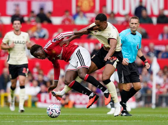 Manchester, England, 30th August 2026. Kobbie Mainoo of Manchester United, ManU challenges Emersonn of Ipswich Town during the Manchester United vs Ipswich Town Premier League match at Old Trafford, Manchester. Picture credit should read: Andrew Yates Sportimage EDITORIAL USE ONLY. No use with unauthorised audio, video, data, fixture lists, club league logos or live services. Online in-match use limited to 120 images, no video emulation. No use in betting, games or single club league player publications. SPI_033_AY_Man_Utd_Ipswich SPI-4945-0033