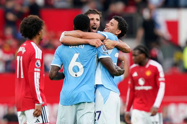 Manchester, England, 13th September 2026. Ruben Dias of Manchester City (C) celebrates at the final whistle with Marc Guehi of Manchester City (L) and Matheus Nunes of Manchester City during the Manchester United, ManU vs Manchester City Premier League match at Old Trafford, Manchester. Picture credit should read: Andrew Yates Sportimage EDITORIAL USE ONLY. No use with unauthorised audio, video, data, fixture lists, club league logos or live services. Online in-match use limited to 120 images, no video emulation. No use in betting, games or single club league player publications. SPI_109_AY_MAN_UTD_MAN_CITY SPI-4993-0102