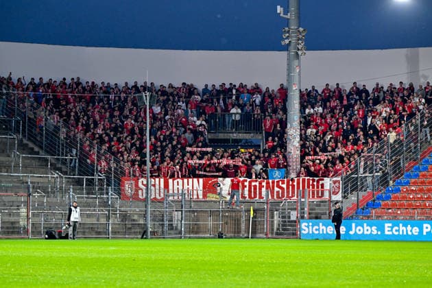 Regensburger Fans, voller Gästefanblock, Fans, Publikum, Zuschauer, Stimmung, Atmosphaere, Stadion, 06.10.2026, Unterhaching (Deutschland), Fussball, BFV Verbandspokal, Viertelfinale, SpVgg Unterhaching - SSV Jahn Regensburg