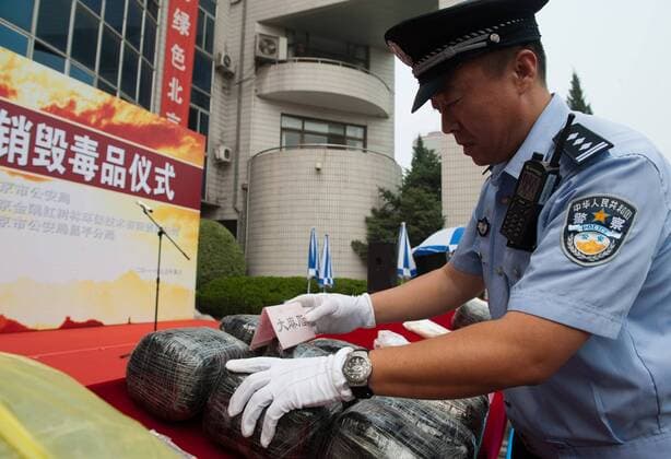 (110619) -- BEIJING, Jun. 19, 2011 (Xinhua) -- A police officer demonstrates confiscated drugs in Beijing, capital of China, June 19, 2011. A batch of drugs, with a worth of 260 million yuan (40.2 million dollars) on the black market, was destroyed in Beijing on Sunday. Weighing 489.39kg in total, the batch of drugs, including heroin, methamphetamine, ecstacy pills, coccaine and marijuana, was confiscated by the police in Beijing in 2008 and 2009 as crime evidences. (Xinhua Zhang Yu) (lmm) CHINA-BEIJING-DRUG DESTRUCTION (CN)