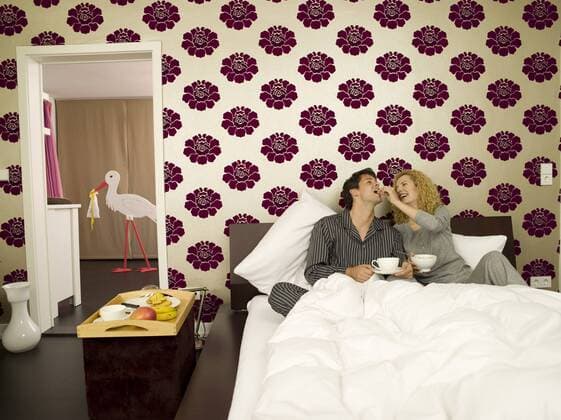 Young couple having breakfast in Bed model released property released WESTF06683