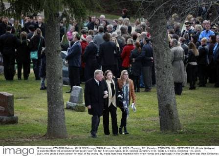 Dec. 10, 2015 - Toronto, ON, Canada - TORONTO, ON - DECEMBER 10 - Nicole Wellwood is escorted from the gravesite of her seven-year-old son Evan Leversage, at St. George Cemetery in St. George, Ontario, December 10, 2015. Evan, who battled brain cancer for most of his young life, made headlines internationally when homes and businesses in the Ontario town put their Christmas decorations up in October, after doctors told his family he was unlikely to live to Christmas and they should celebrate early. Toronto Canada - ZUMAt14_